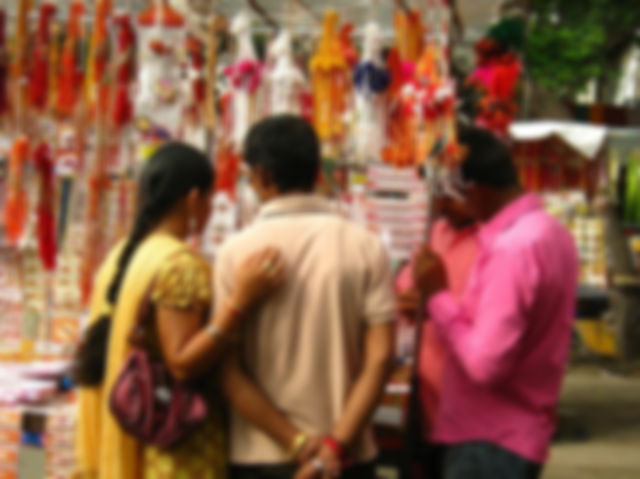 A woman and man shop for rakhi