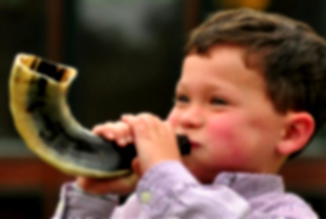 A child blowing shofar