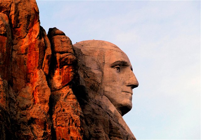 The face of George Washington on Mount Rushmore, the right side of his face in sunset