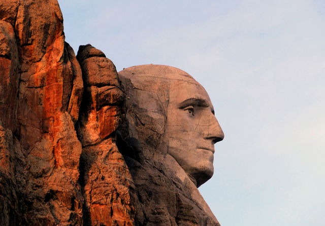 The face of George Washington on Mount Rushmore, the right side of his face in sunset