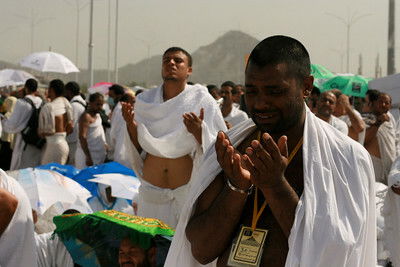 A man praying near Mountain Arafat on the Day of Arafah