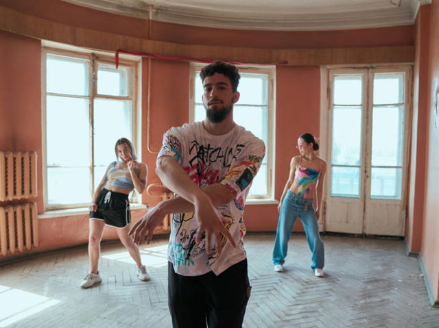 A man and two women dancing