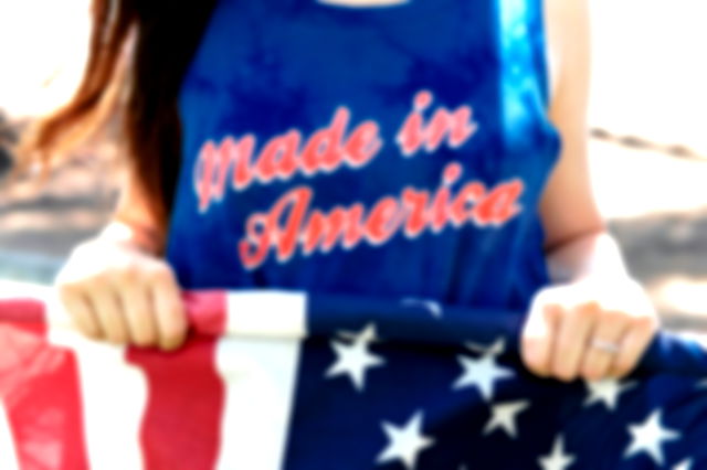 A woman wearing an American t shirt containing the colors of the American flag
