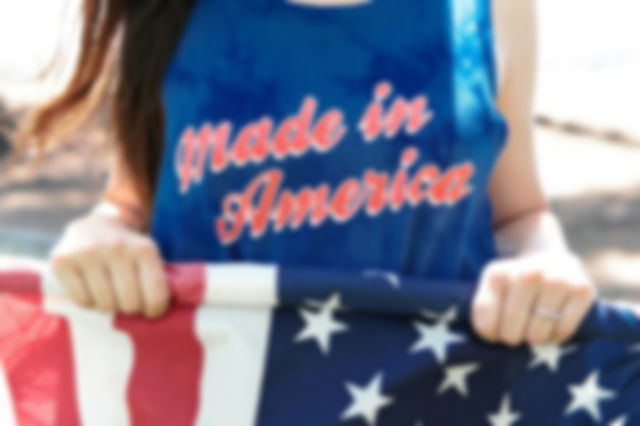 A woman wearing an American t shirt containing the colors of the American flag