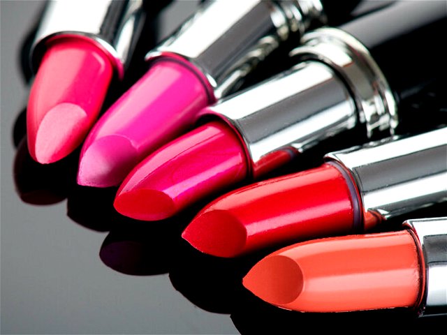 Colorful Lipsticks over black background