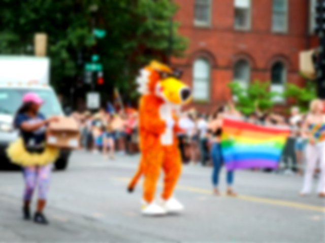 Chester Cheetah mascot in a pride parade
