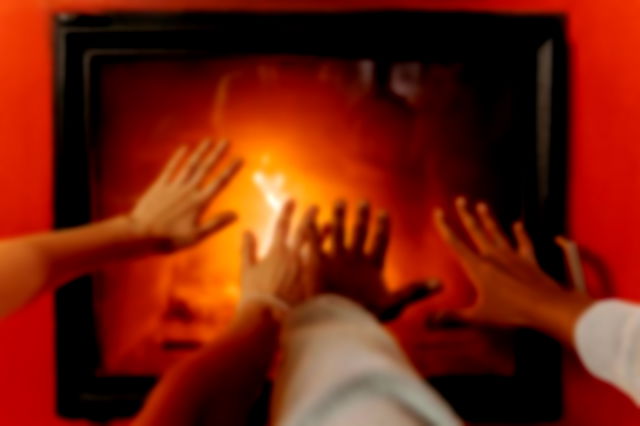 Couples Hands By Fireplace