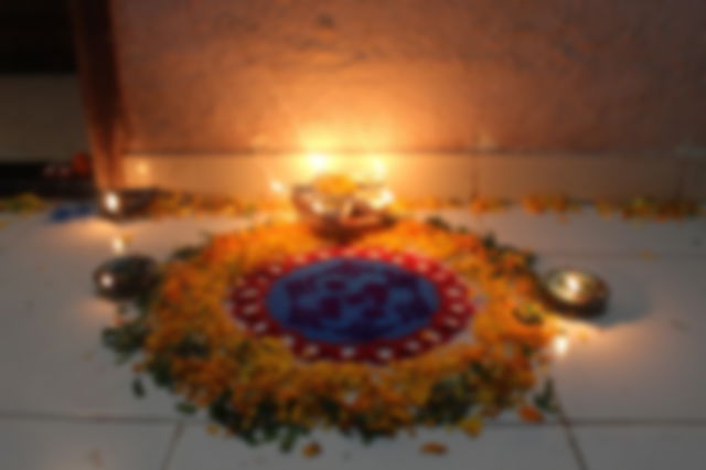 A rangoli pattern decorating the entrance of a building