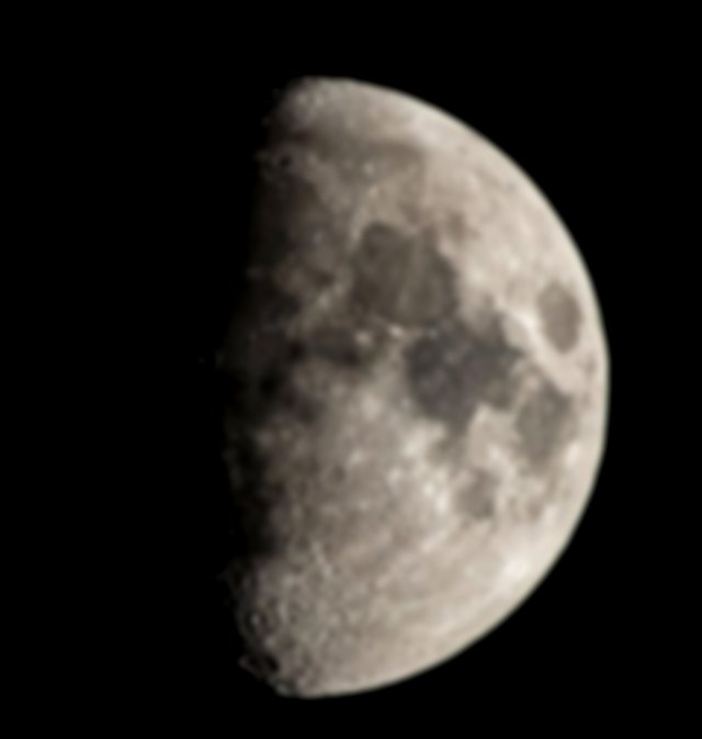 An Image Of A First Quarter Moon
