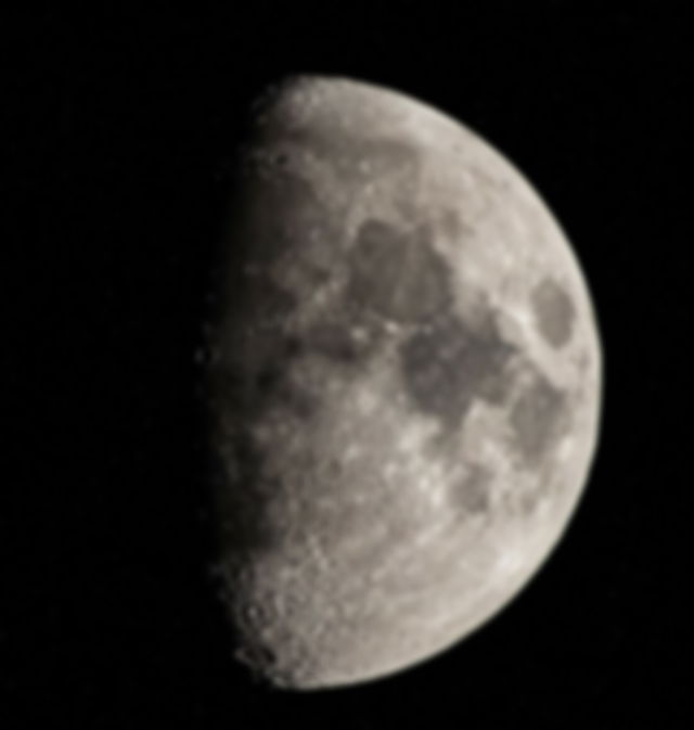 An Image Of A First Quarter Moon