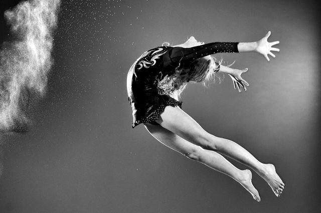 A greyscale image of a child jumping mid air