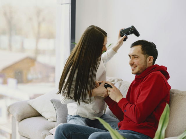 Happy couple playing video games