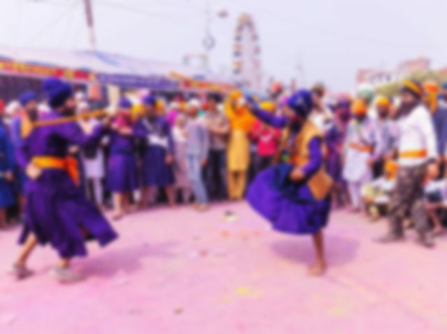 Anandpur Sahib, Punjab, India - March 19 2022: Portrait of sikh male (Nihang Sardar) performing martial art as culture during the celebration of Hola Mohalla at