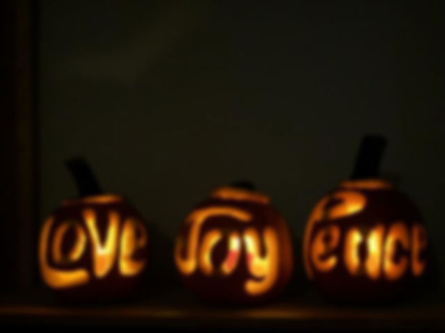 peace, joy and love carved into pumpkins