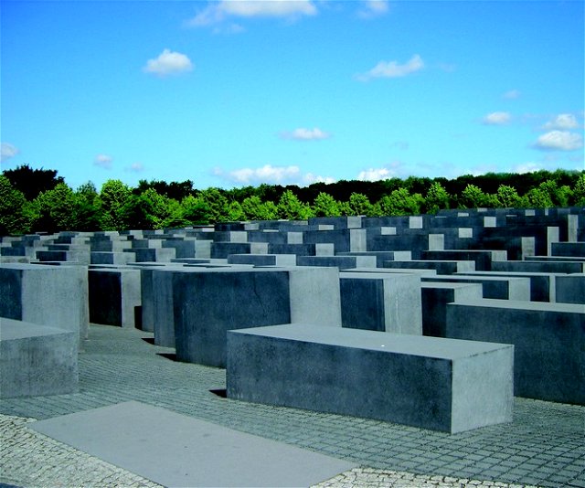 Concrete slabs in rows, with trees and a bright blue sky