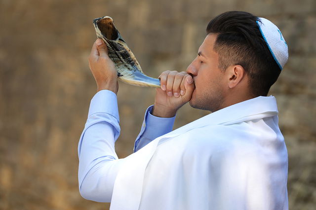 homem tocando shofar