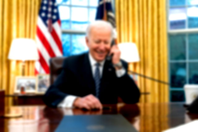 President Joe Biden talks on the phone with Katherine Tai in the Oval Office of the White House