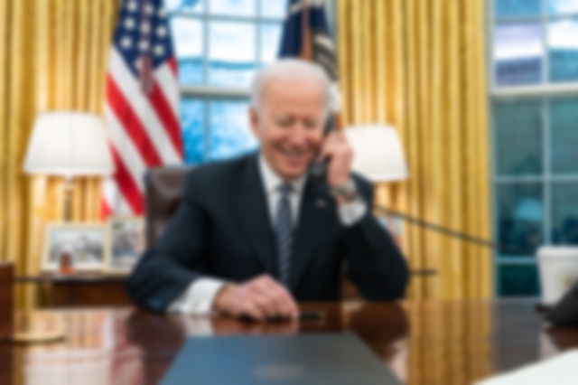 President Joe Biden talks on the phone with Katherine Tai in the Oval Office of the White House