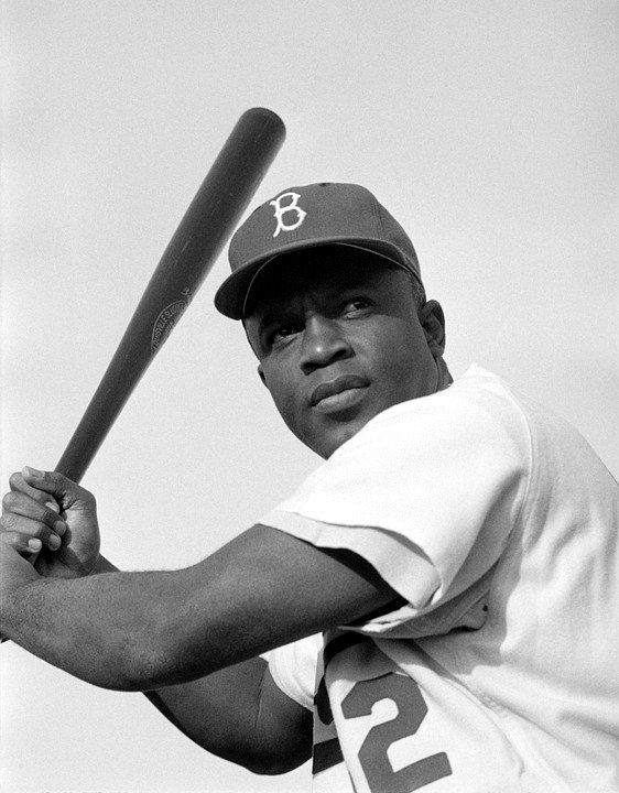 An Image Of Jackie Robinson Holding A Baseball bat