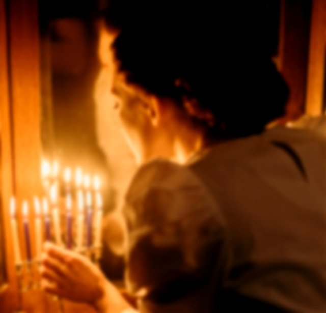 Jewish Woman lighting candles on Rosh Hashanah