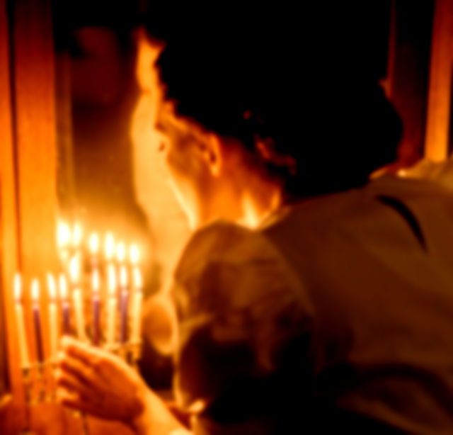 Jewish Woman lighting candles on Rosh Hashanah