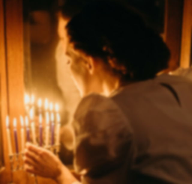 Jewish Woman lighting candles on Rosh Hashanah