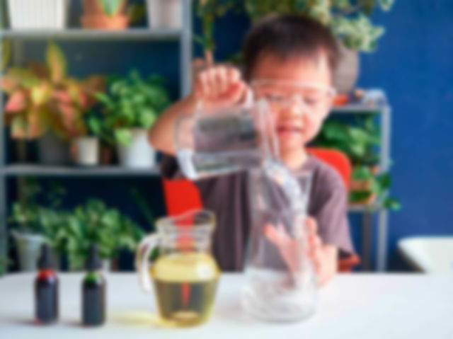 An Asian kid trying a science experiment