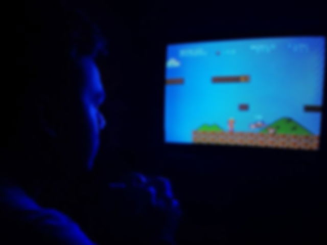 Photo of Man Playing Super Mario Bros