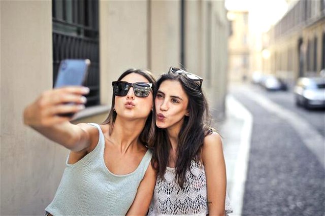 Two girls taking a selfie while pouting