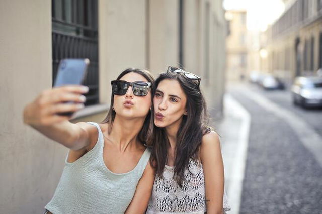 Two girls taking a selfie while pouting