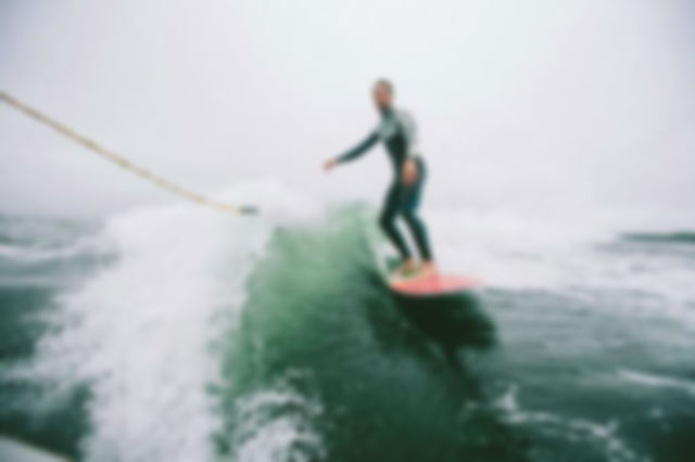 Man in a Wet Suit Surfing