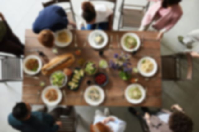 family sat a table eating together