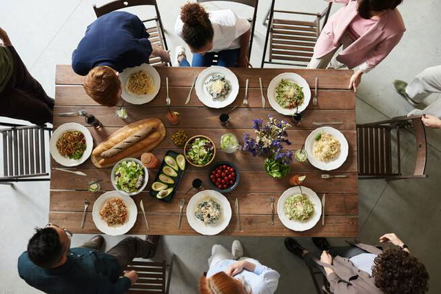 family sat a table eating together