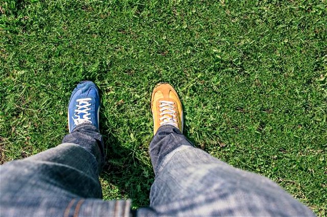 A person wearing different shoes