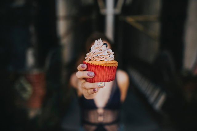 woman holding cupcake