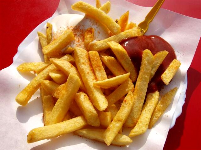 A serving of french fries with ketchup