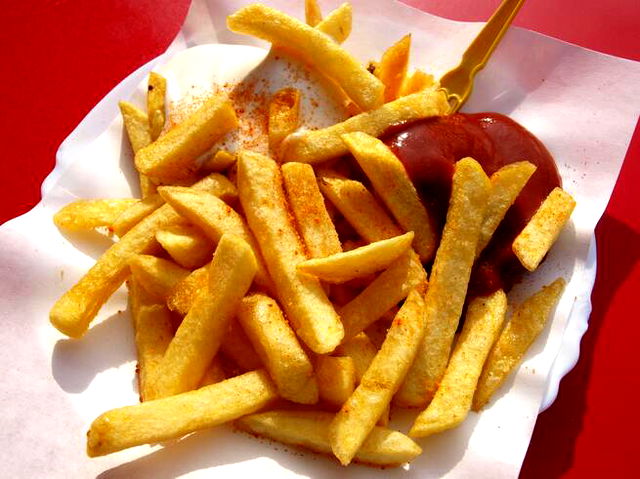 A serving of french fries with ketchup