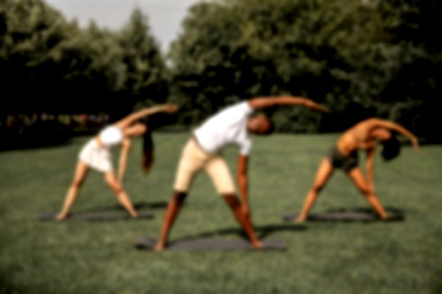 Three people doing yoga on a ground