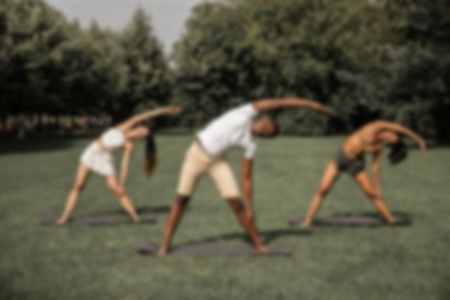 Three people doing yoga on a ground