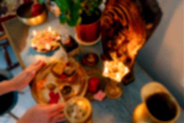 A Person Putting Golden Plate with Food on the Altar