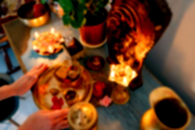 A Person Putting Golden Plate with Food on the Altar