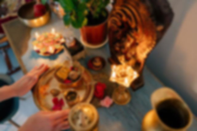 A Person Putting Golden Plate with Food on the Altar