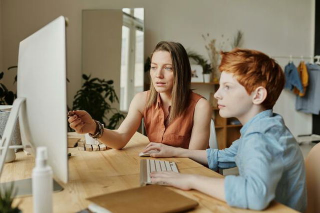 Photo Of Woman educating a Young Boy