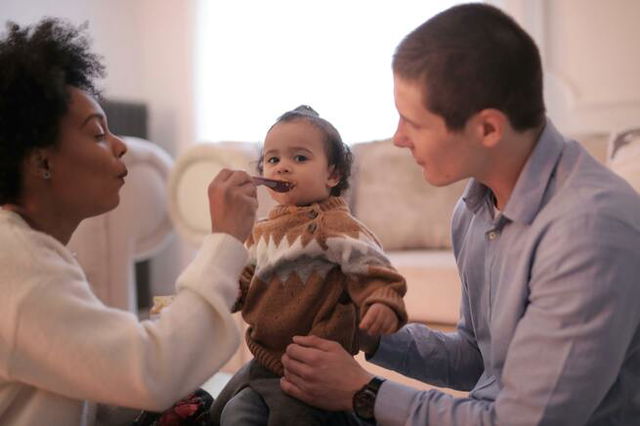 Photo of Woman Feeding Her Child