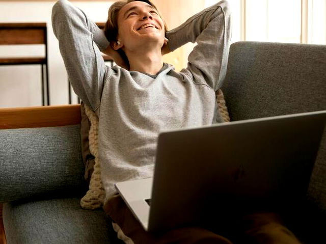 Photo Of Man Sitting On Sofa