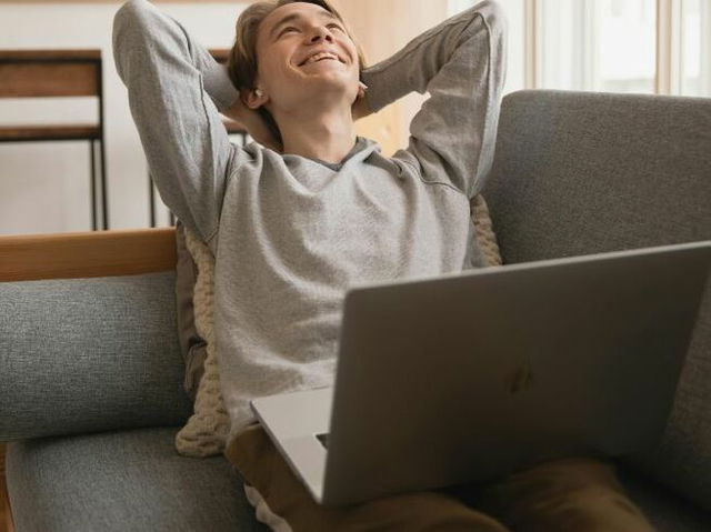 Photo Of Man Sitting On Sofa