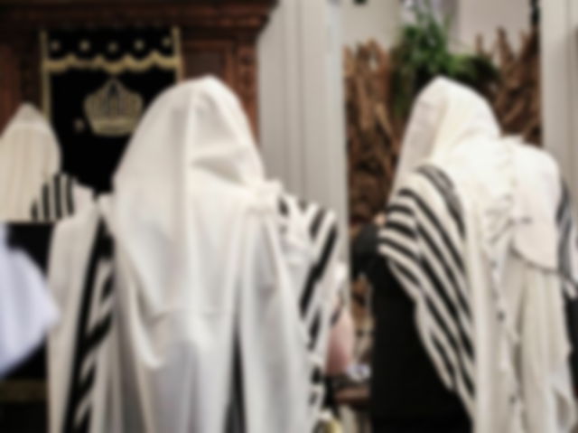 Two orthodox religious jewish men in prayer shawls on Rosh Hashanah