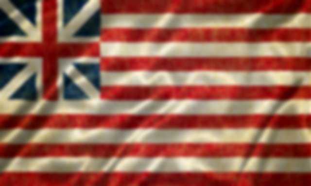 A flag with The Union Jack in the top left corner instead of the American blue background and stars, thirteen red and white stripes.