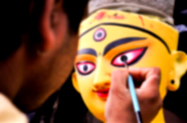 Drawing the eyes of Maa Durga on Mahalaya