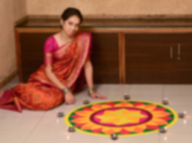 A Marathi woman making rangoli on Gudi Padwa